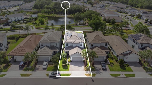 drone / aerial view featuring a water view and a residential view