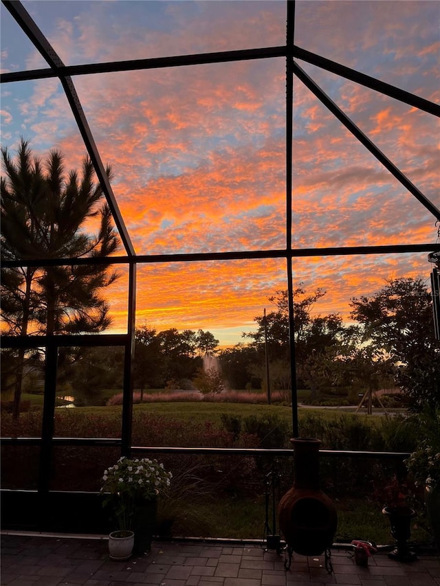 patio terrace at dusk featuring a lanai