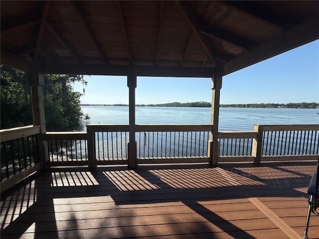 dock area featuring a gazebo and a deck with water view