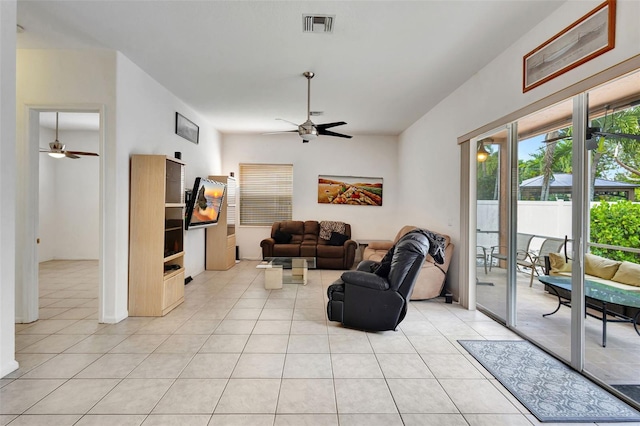 living area featuring light tile patterned floors, a ceiling fan, and visible vents