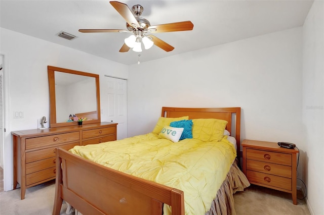 bedroom featuring visible vents, ceiling fan, and light colored carpet
