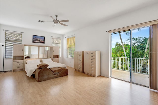 bedroom with light wood-style floors, access to exterior, and multiple windows