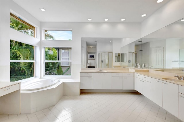 bathroom featuring a bath, tile patterned floors, recessed lighting, and a stall shower