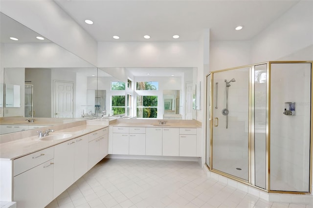bathroom featuring tile patterned floors, a sink, and a stall shower