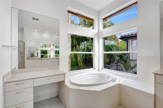 bathroom with a garden tub, a shower stall, vanity, tile patterned flooring, and visible vents