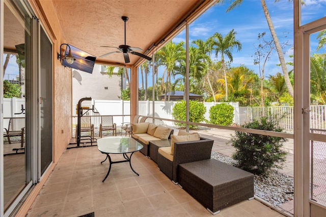 sunroom / solarium with an outdoor living space and ceiling fan