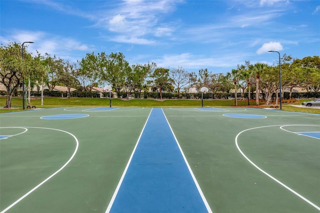 view of basketball court with a yard and community basketball court