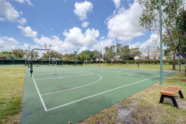 view of basketball court featuring community basketball court and a lawn