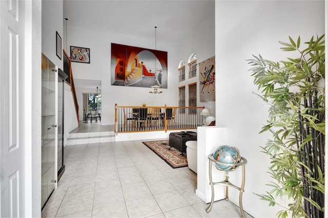 entrance foyer featuring a high ceiling and tile patterned flooring