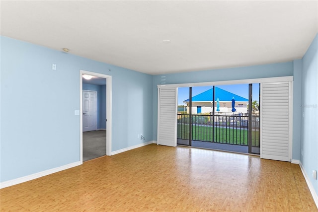 2700 N Peninsula Ave Unit 215, New Smyrna Beach, FL 32169 - spare room featuring wood finished floors and baseboards