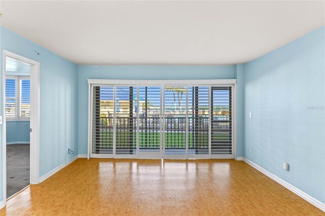 2700 N Peninsula Ave Unit 215, New Smyrna Beach, FL 32169 - spare room featuring baseboards and wood finished floors