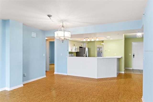 2700 N Peninsula Ave Unit 215, New Smyrna Beach, FL 32169 - interior space with baseboards, wood finished floors, and an inviting chandelier
