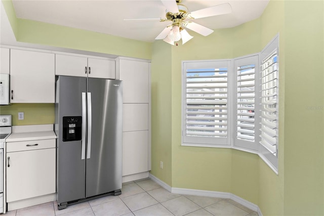 2700 N Peninsula Ave Unit 215, New Smyrna Beach, FL 32169 - kitchen with white cabinets, plenty of natural light, white microwave, and stainless steel fridge with ice dispenser