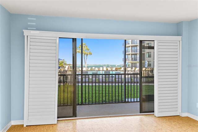 2700 N Peninsula Ave Unit 215, New Smyrna Beach, FL 32169 - doorway featuring baseboards and wood finished floors