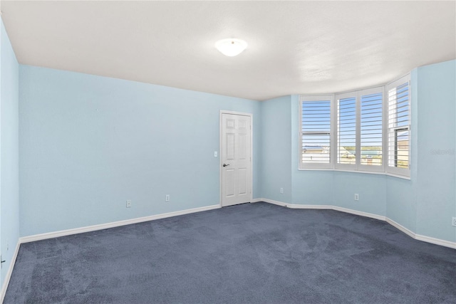 2700 N Peninsula Ave Unit 215, New Smyrna Beach, FL 32169 - spare room with dark carpet and baseboards