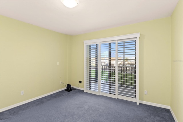 2700 N Peninsula Ave Unit 215, New Smyrna Beach, FL 32169 - unfurnished room with dark colored carpet and baseboards