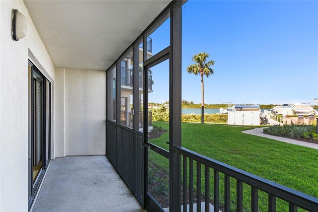 2700 N Peninsula Ave Unit 215, New Smyrna Beach, FL 32169 - unfurnished sunroom with plenty of natural light and a water view