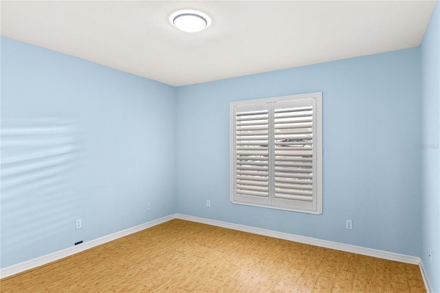 2700 N Peninsula Ave Unit 215, New Smyrna Beach, FL 32169 - spare room featuring baseboards and wood finished floors