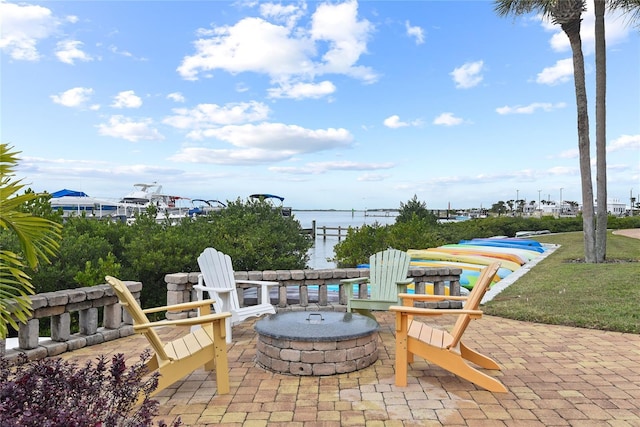 2700 N Peninsula Ave Unit 215, New Smyrna Beach, FL 32169 - view of patio with a fire pit and a water view