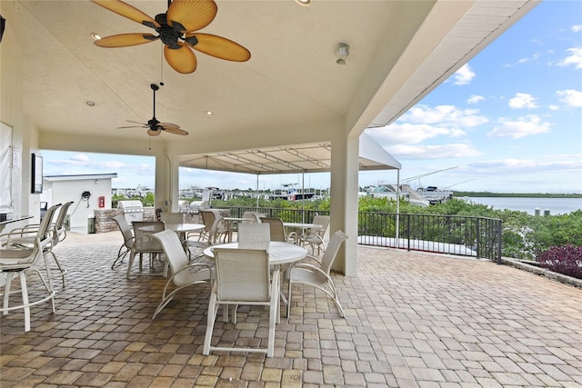 2700 N Peninsula Ave Unit 215, New Smyrna Beach, FL 32169 - view of patio / terrace featuring grilling area, a water view, outdoor dining space, and ceiling fan