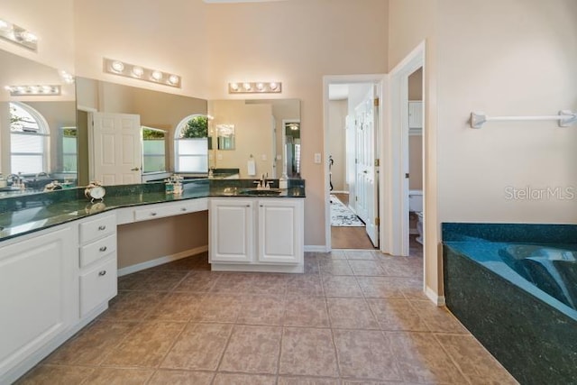 2082 Nexus Ct, Apopka, FL 32712 - bathroom with tile patterned floors, a garden tub, vanity, and a high ceiling