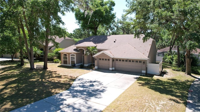 2082 Nexus Ct, Apopka, FL 32712 - mediterranean / spanish-style house featuring a garage, concrete driveway, and a shingled roof