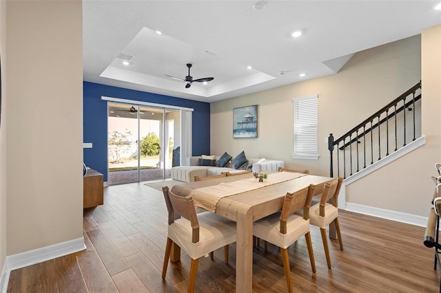 10215 Park Estates Ave, Orlando, FL 32836 - dining space featuring baseboards, a ceiling fan, wood finished floors, and a raised ceiling