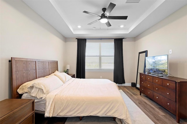 10215 Park Estates Ave, Orlando, FL 32836 - bedroom with recessed lighting, a tray ceiling, wood finished floors, baseboards, and ceiling fan