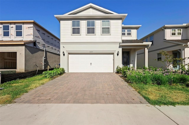 10215 Park Estates Ave, Orlando, FL 32836 - traditional-style house with an attached garage, stucco siding, and decorative driveway