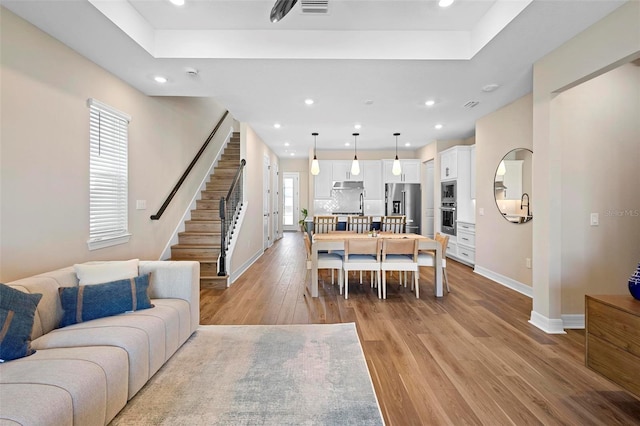 10215 Park Estates Ave, Orlando, FL 32836 - living room featuring baseboards, stairs, light wood finished floors, and recessed lighting