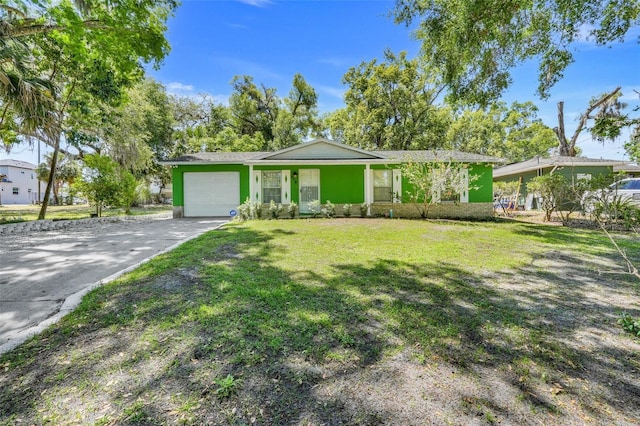 ranch-style house featuring a garage, driveway, and a front lawn