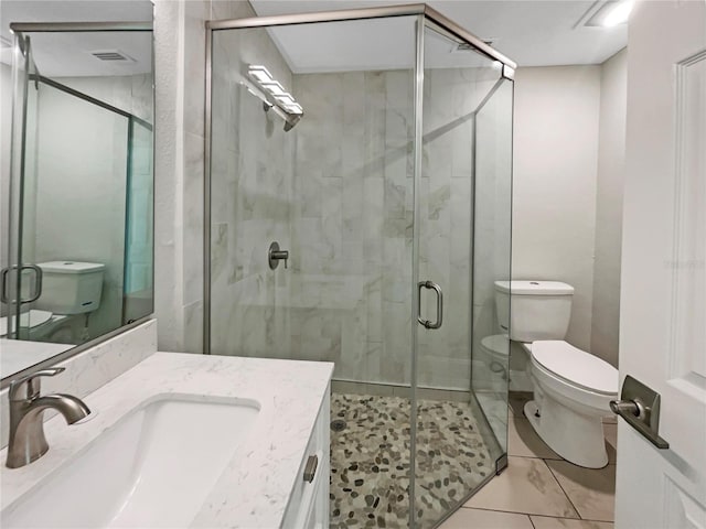 bathroom with toilet, a stall shower, and vanity