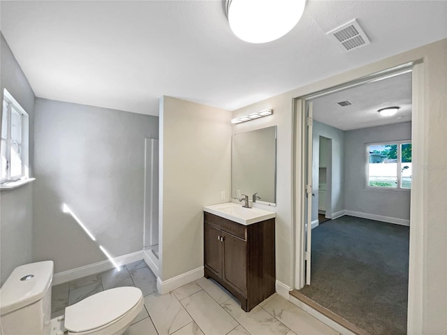 bathroom with vanity, baseboards, toilet, visible vents, and marble finish floor