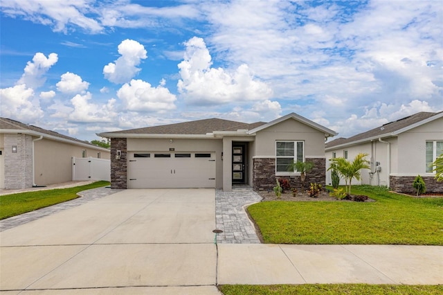 236 Pink Ibis Bnd, Saint Cloud, FL 34772 - view of front of house featuring stucco siding, an attached garage, driveway, stone siding, and a front yard