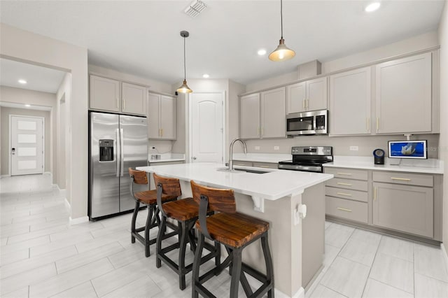 236 Pink Ibis Bnd, Saint Cloud, FL 34772 - kitchen with visible vents, gray cabinets, stainless steel appliances, and a sink