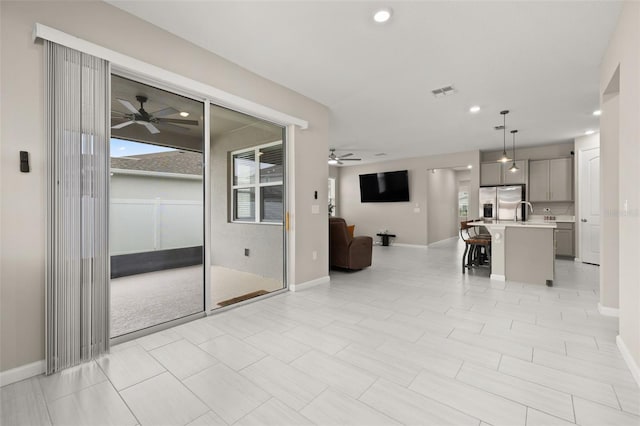 236 Pink Ibis Bnd, Saint Cloud, FL 34772 - unfurnished living room featuring visible vents, a ceiling fan, and baseboards