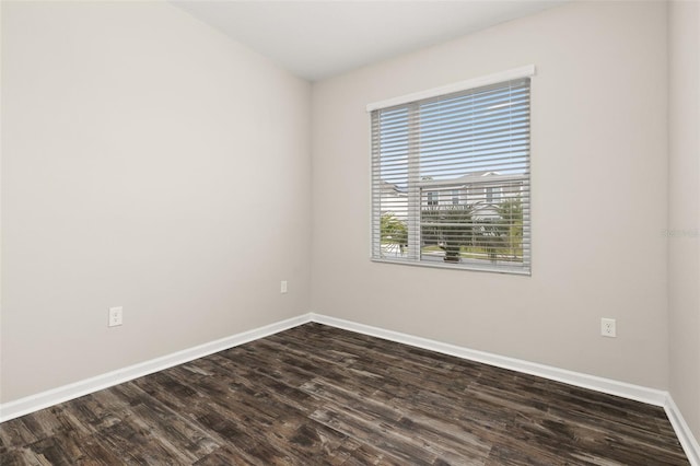 236 Pink Ibis Bnd, Saint Cloud, FL 34772 - empty room with baseboards and dark wood-type flooring