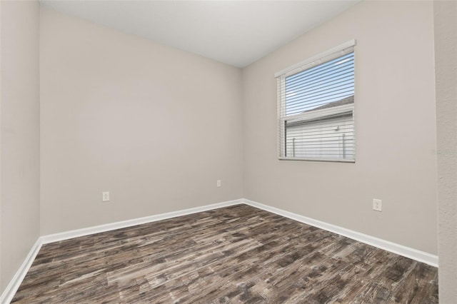 236 Pink Ibis Bnd, Saint Cloud, FL 34772 - unfurnished room with baseboards and dark wood-type flooring