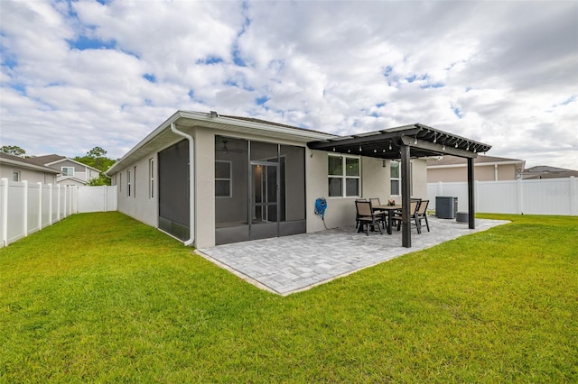 236 Pink Ibis Bnd, Saint Cloud, FL 34772 - back of house featuring a yard, a sunroom, and stucco siding
