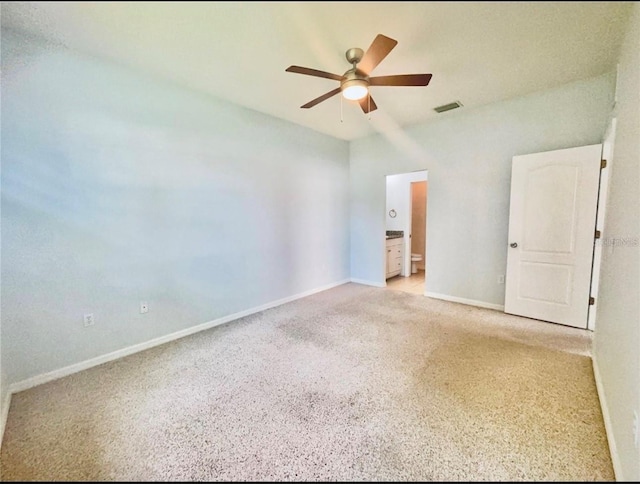 empty room with baseboards, visible vents, light carpet, and a ceiling fan