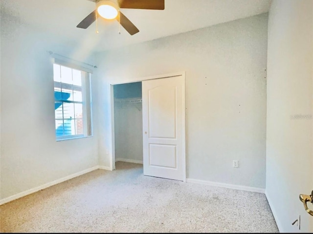 unfurnished bedroom featuring a closet, ceiling fan, carpet, and baseboards