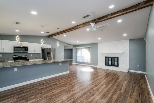 10237 Bannock St, Spring Hill, FL 34608 - kitchen with lofted ceiling with beams, white cabinets, dark wood-style floors, and appliances with stainless steel finishes