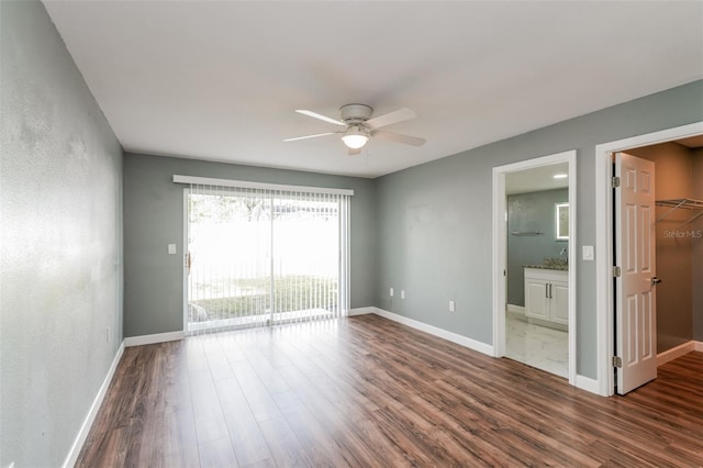 10237 Bannock St, Spring Hill, FL 34608 - spare room with dark wood-style flooring, baseboards, and ceiling fan