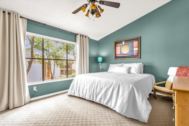 bedroom with vaulted ceiling, a ceiling fan, carpet flooring, and baseboards