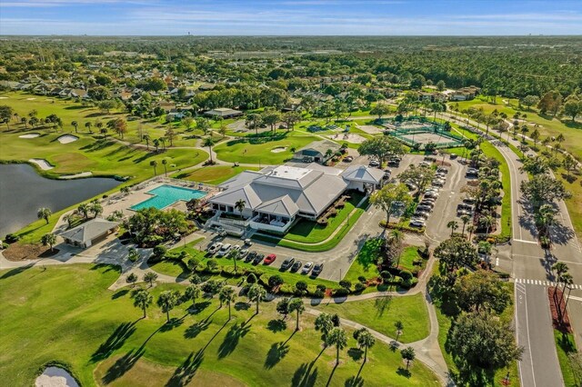 birds eye view of property with golf course view and a water view