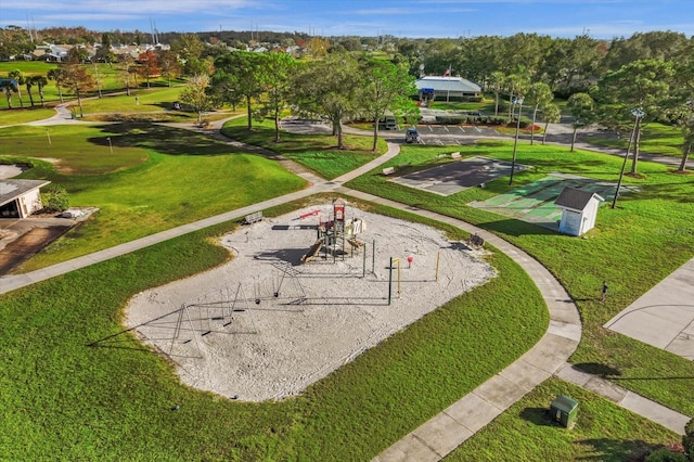 view of community featuring a lawn and shuffleboard