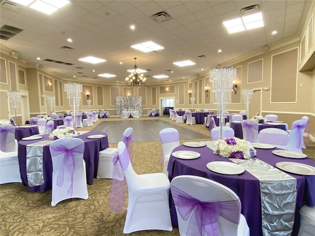 carpeted dining space with visible vents, a notable chandelier, and a decorative wall