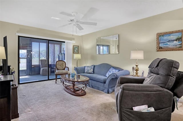 living area featuring carpet floors and ceiling fan