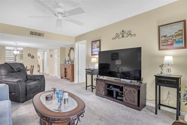 carpeted living room featuring baseboards, visible vents, and ceiling fan