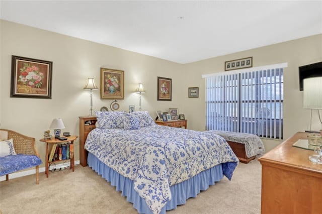 bedroom featuring light carpet